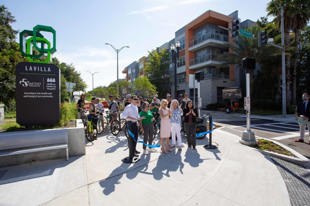 photo shows mayor deegan with four other people cutting a blue ribbon to re-open park street
