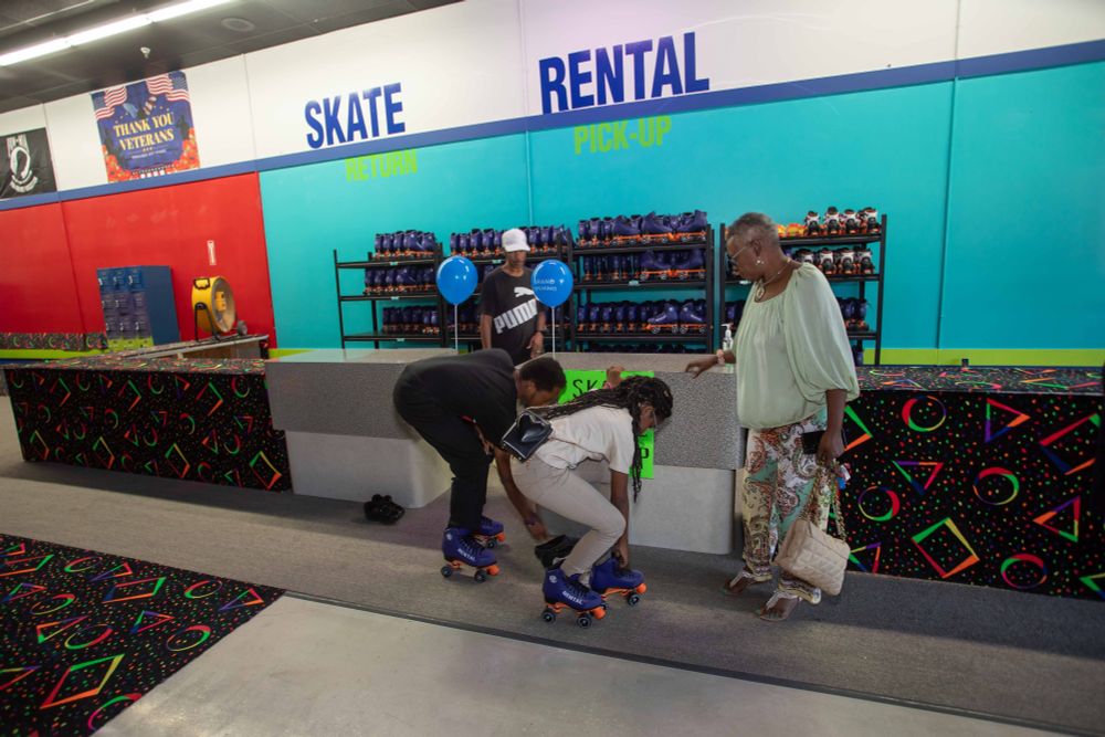 two people putting roller skates on