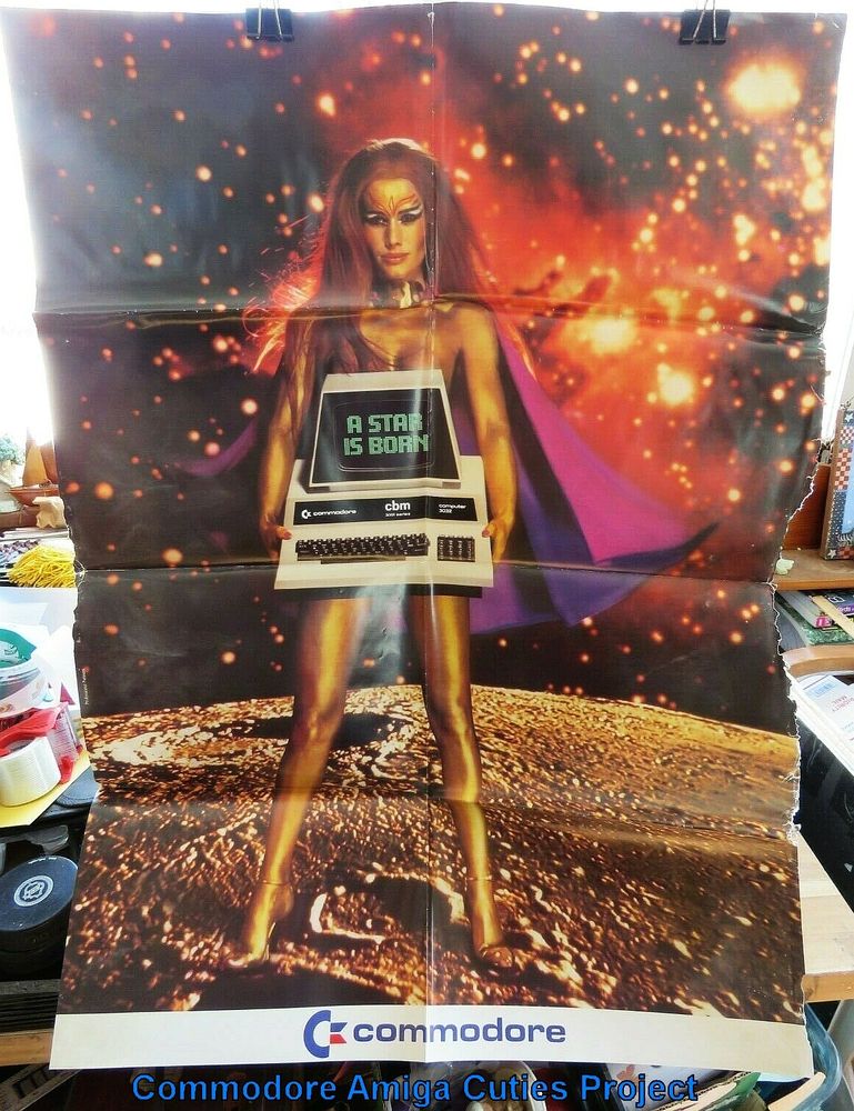 Circa 1980 magazine advert of caped alien superhero woman holding Commodore PET CBM computer. They were heavy! 