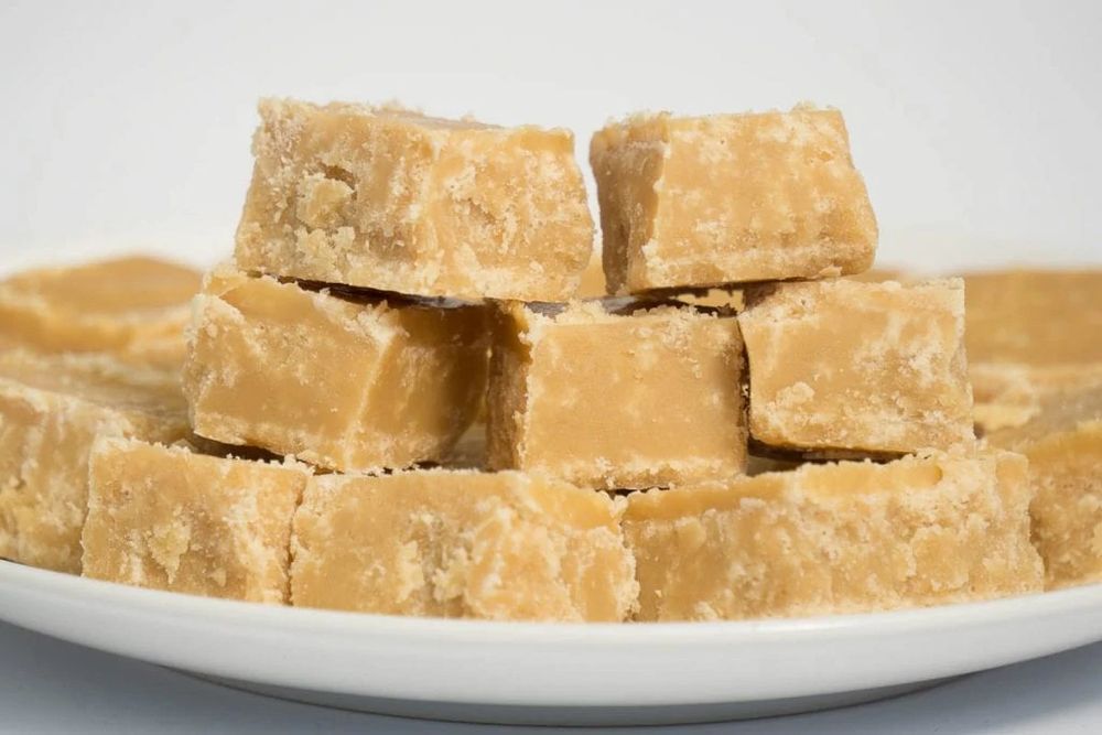 A photograph of a stack of delicious beige cubes of tablet. I call it Scottish tablet. I accidentally made it when a fudge recipe went wrong. It’s crumbly rich sweet buttery goodness and in many ways it’s more satisfying than fudge. 