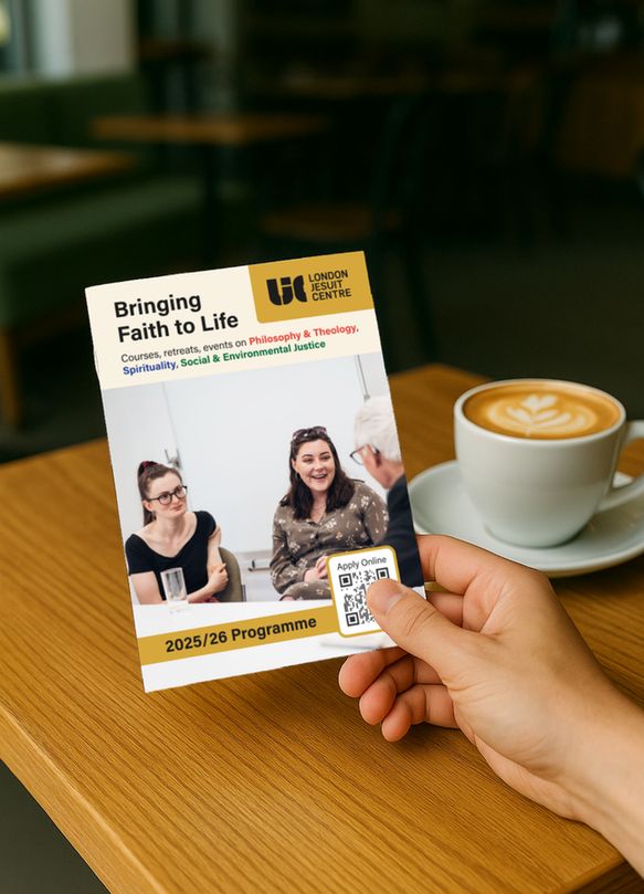 A person holds a brochure in a coffee shop titled "Bringing Faith to Life," featuring a photo of three smiling people in conversation, with a latte in the background.