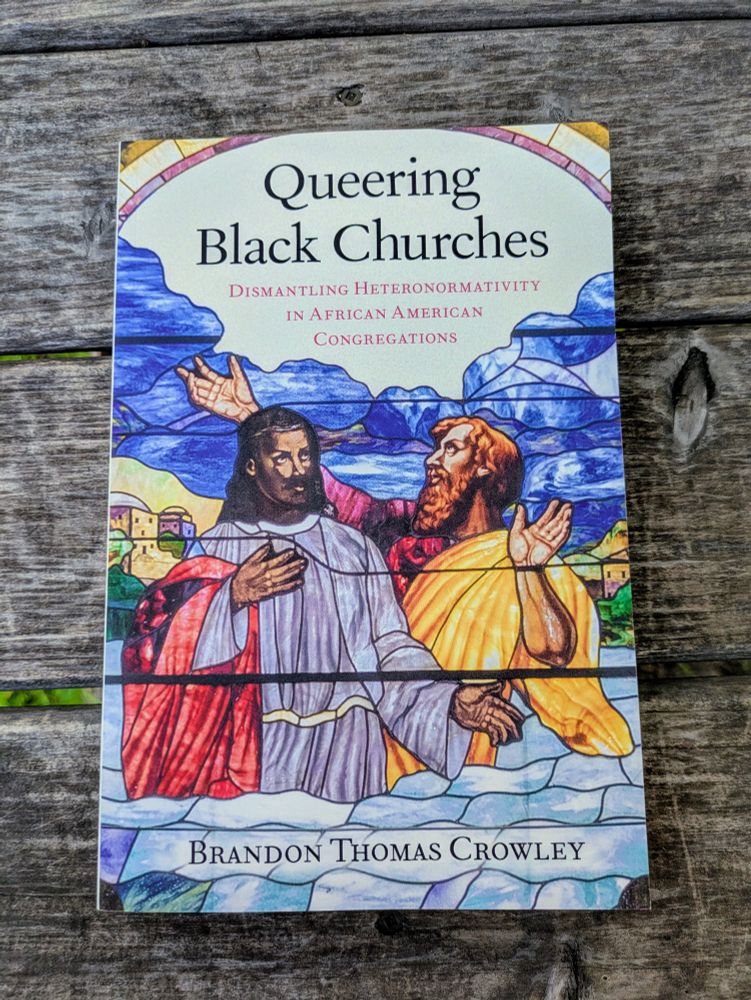 Cover of the book Queering Black Churches: Dismantling Heteronormativity in African American Congregations by Brandon Thomas Crowley. The artwork resembles stained glass, depicting two figures in religious robes with uplifted hands, set against a backdrop of hills and buildings. The design evokes sacred imagery while signaling themes of inclusion, resistance, and transformation within Black church communities.