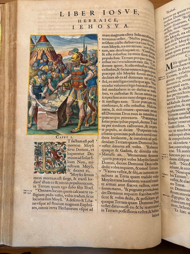Page in the book with printed text of the book of Joshua with an engraving opening the text, which is handcoloured