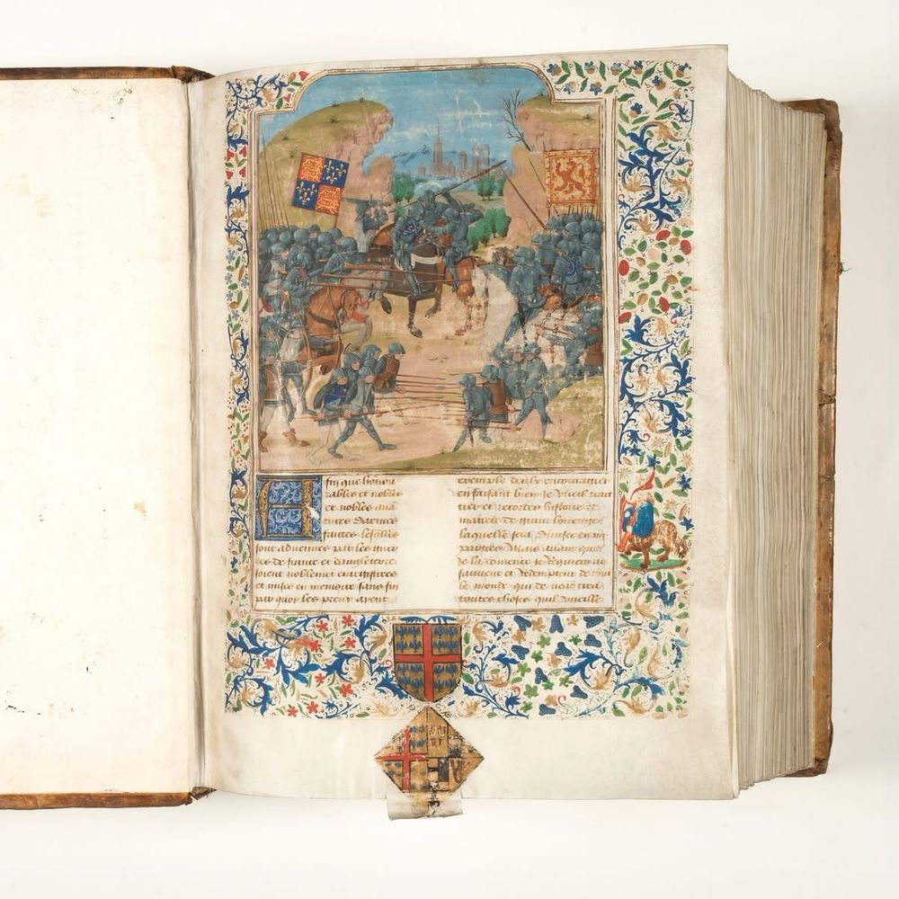 First page in a volume of the Chroniques by Jean Froissart. A book handwritten on parchment with a half-page miniature depicting a contemporary scene and decorated illuminated borders.