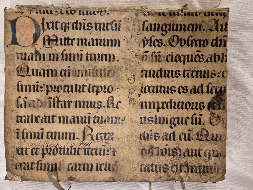 Upper cover of the ledger with a medieval manuscript in a gothic hand together with a decorated initial letter D