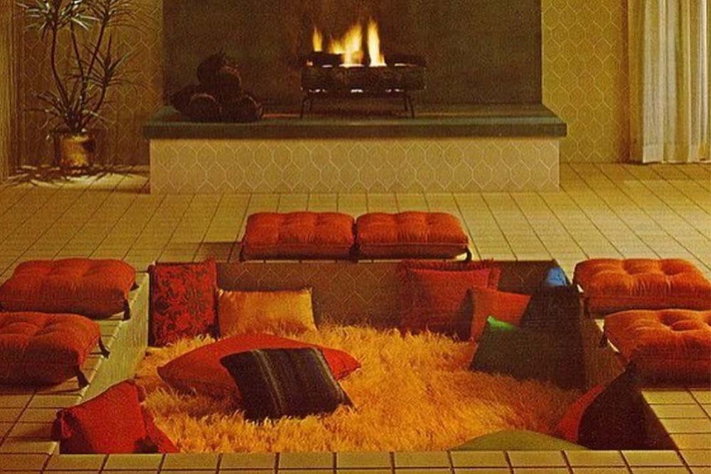1970s conversation pit with shag rug and orange floor cushions. Cozy vibe