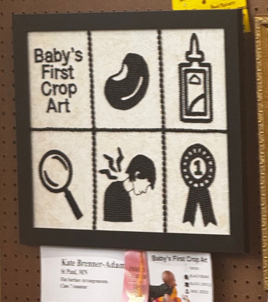 black and white baby’s first crop art made from seeds