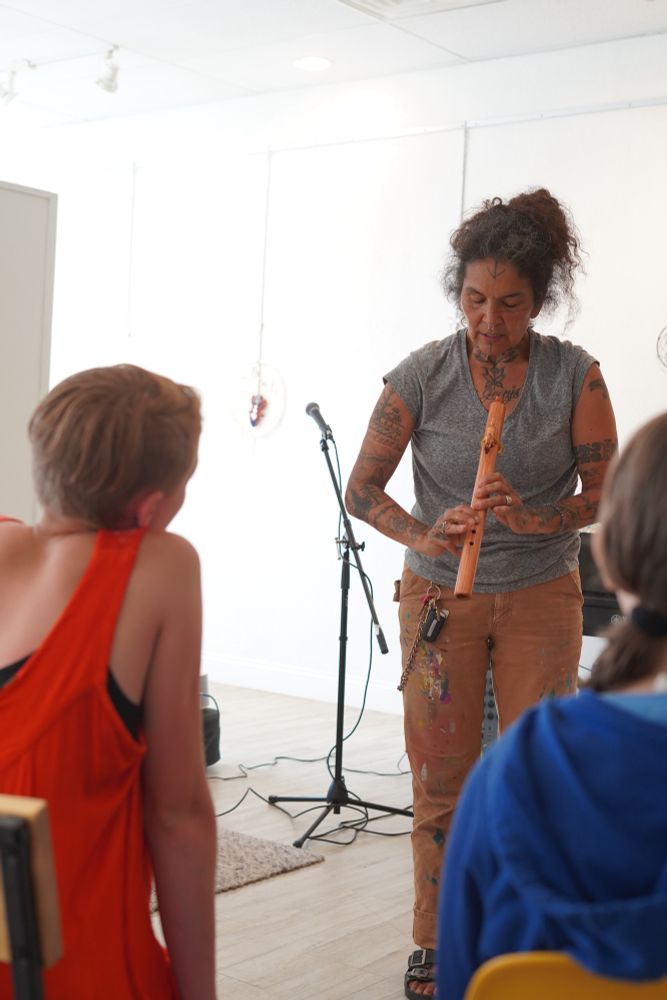 annie teaches kids to play a flute