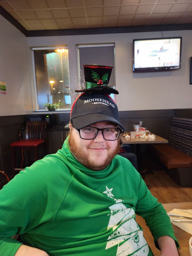 me wearing my top hat headband over the snapback cap I won smiling cuz I know it looks silly