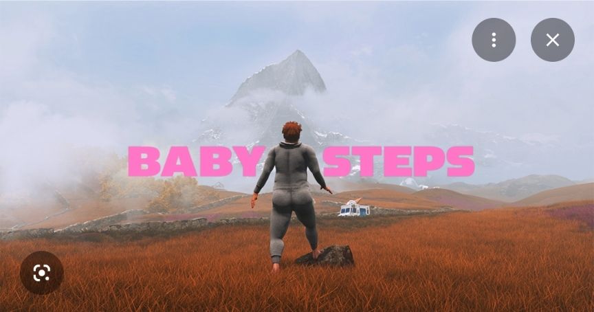 Pink text reading "baby steps" bookends an out-of-shape man in a large grey onesie. He stands in a rusty-coloured grass field before a vista of a mountain blanketed in some low clouds. 