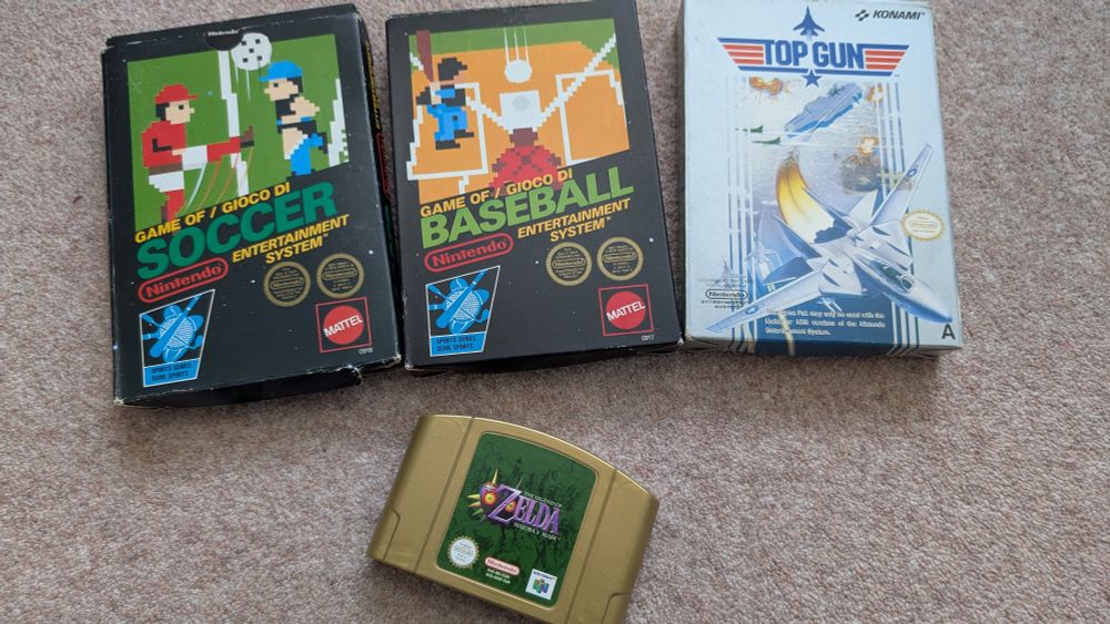 3 nes games and an N64 game. The nes games are soccer, baseball, and top gun. All in box with manual. The N64 game is majora's mask gold edition, game only. 