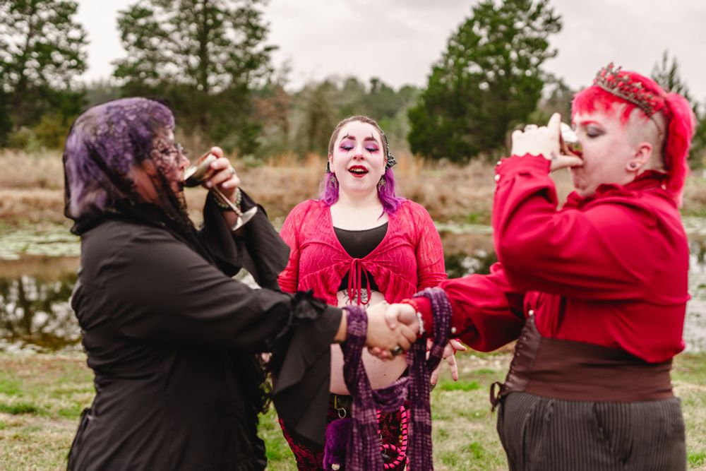 Kit (he/they/it/xe) and Ryland (they/he) at their wedding, officiated by Jynxx (they/them). 