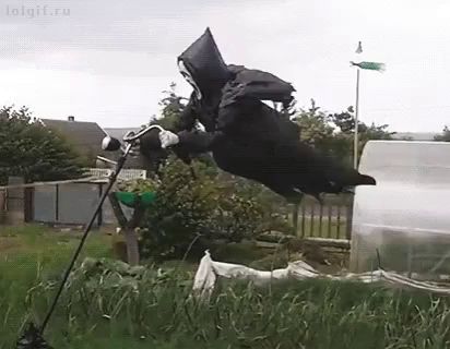 a grim reaper is flying through the air while riding a bicycle .