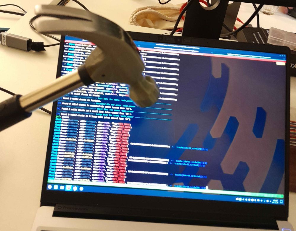 a hammer is brandished in front of a computer screen showing a heap dump of a program