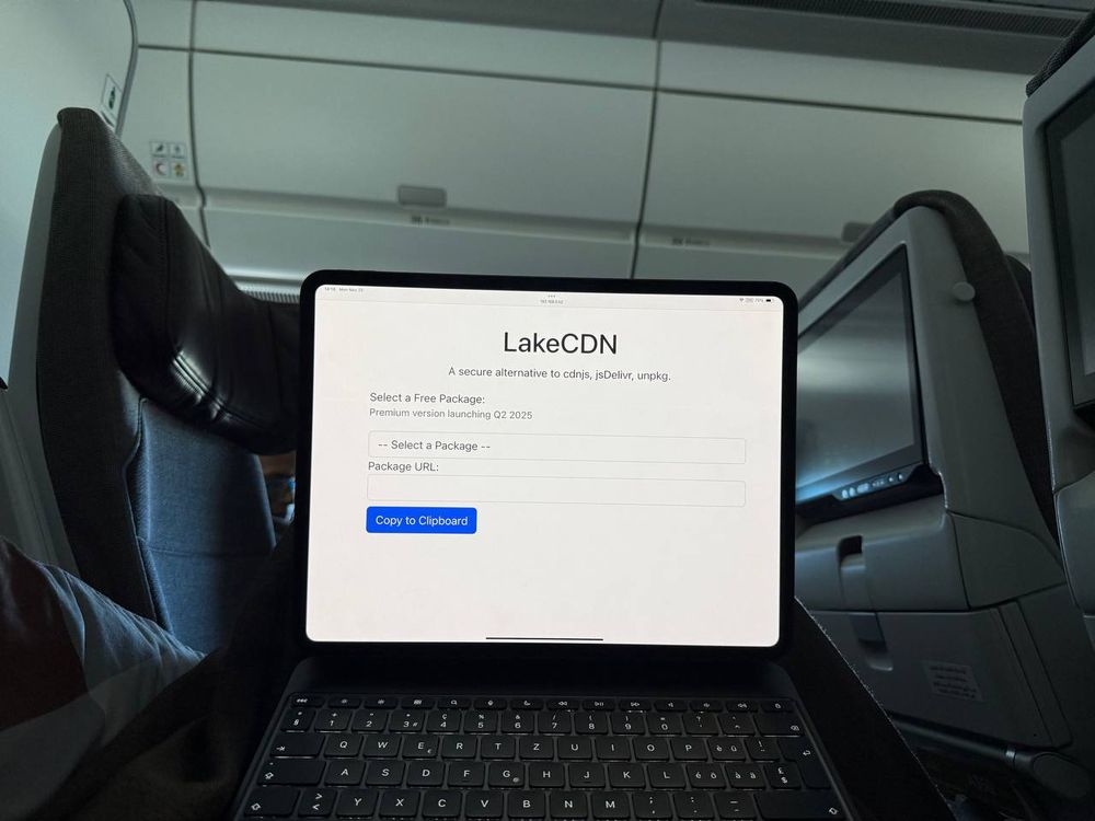 A laptop open in an airliner, with a webpage offering to select a free package from LakeCDN