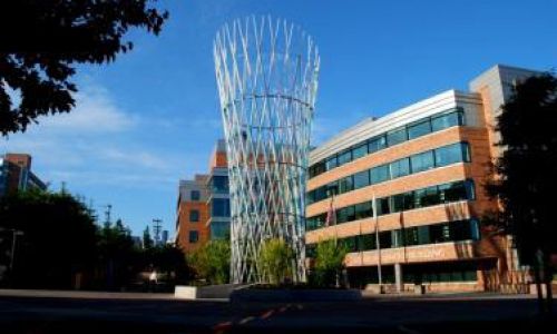 A photo of Fred Hutch Cancer Center in Seattle, with the Arnold buildling and "the Vessel" sculpture in front.