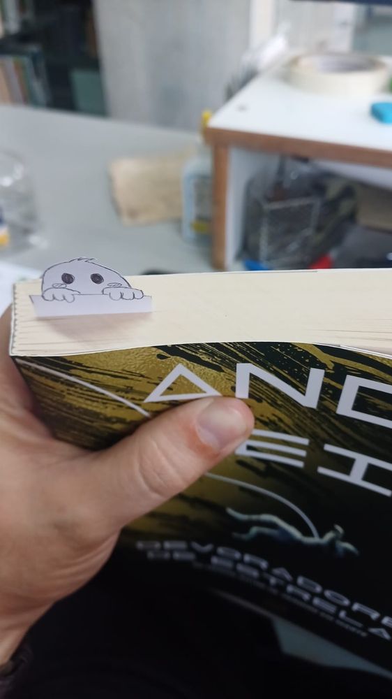 photo of a book with a bookmark shaped like a ghost