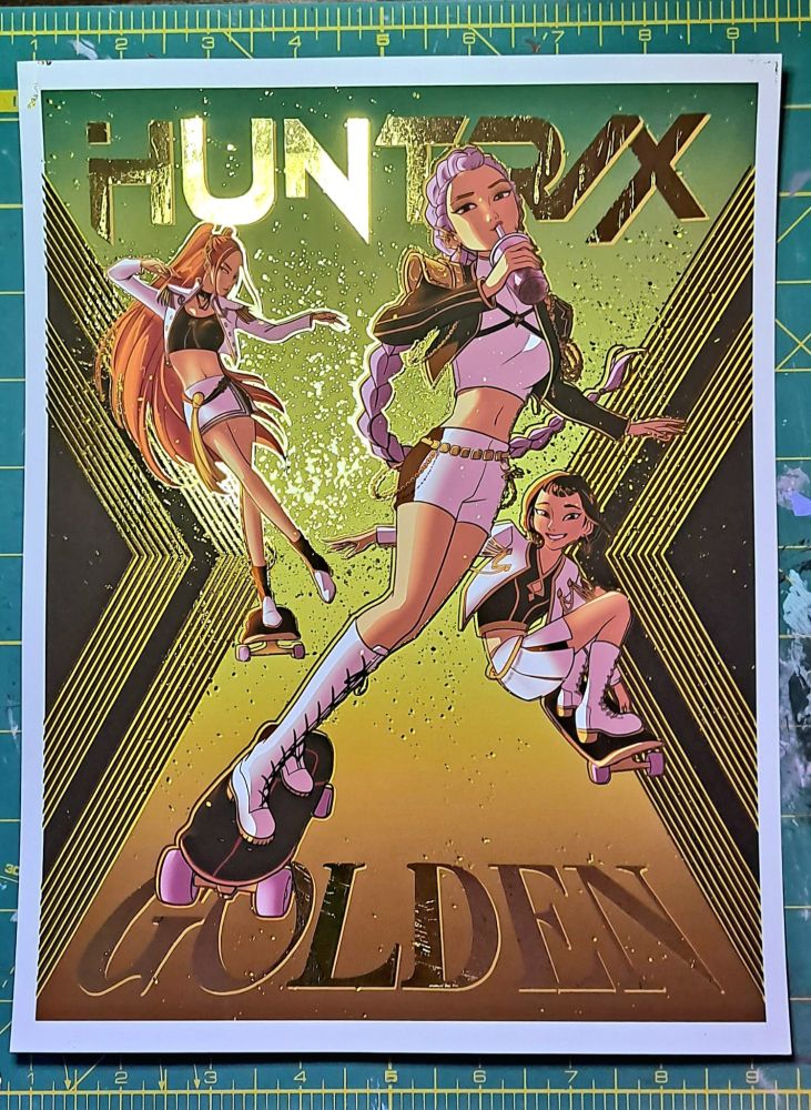 Gold foiled art of HUNTRIX (Rumi, Zoey, and Mira) from Kpop Demon Hunters, skating and drinking boba!