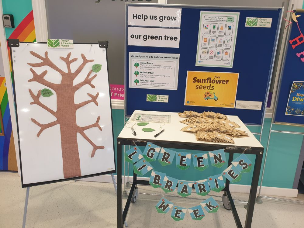 Colour photo of a display board and a table with some seed packets on