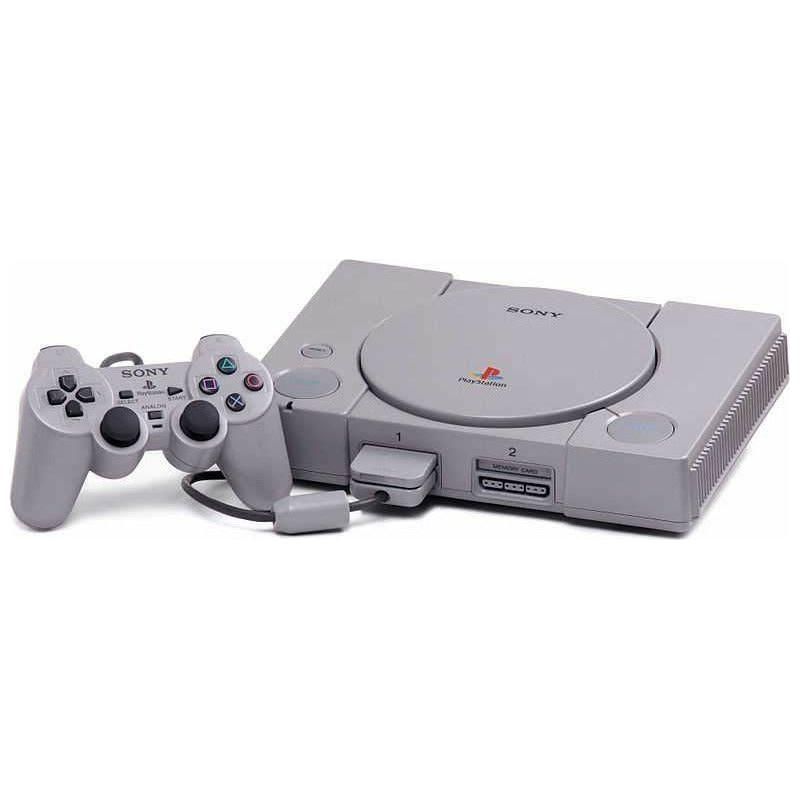 Picture of a PlayStation 1 with controller. It is a grey gaming console shaped like a DVD player.