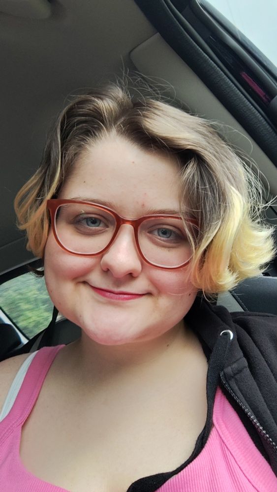 A photo of me in makeup smiling.