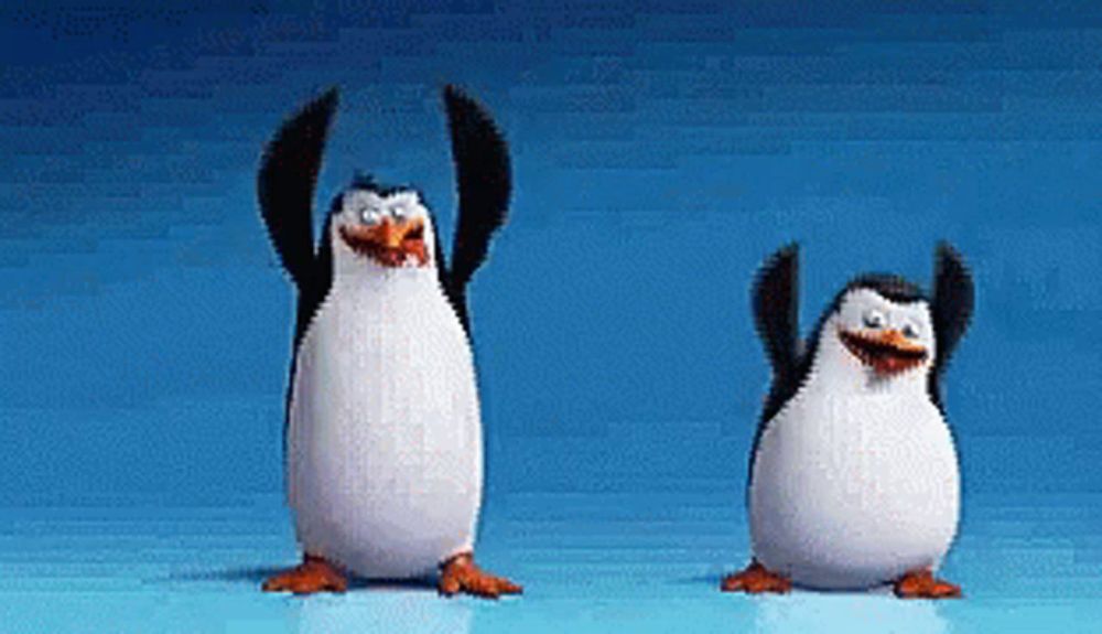 two penguins are standing next to each other on a blue surface