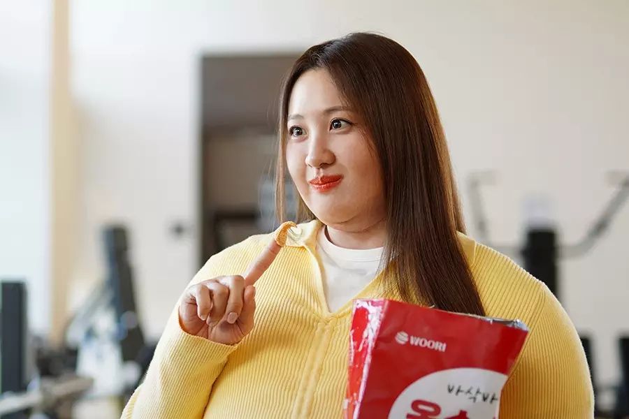 A woman in a fatsuit munches on chips