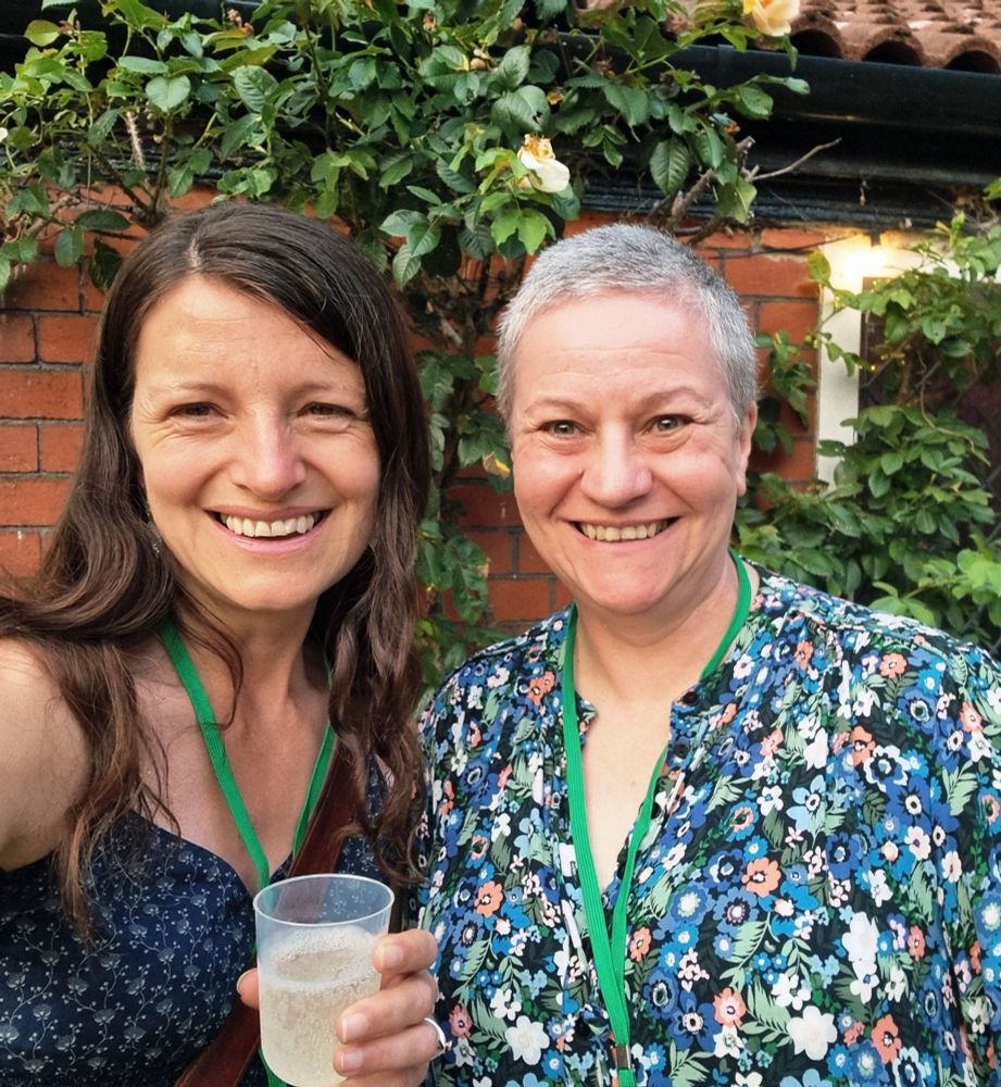 Sarah and JP grinning outside the bar, like a pair of excitable raccoons.