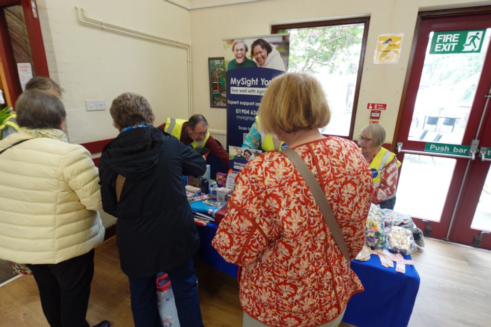 People queuing to have a go on MySight York's tombola.