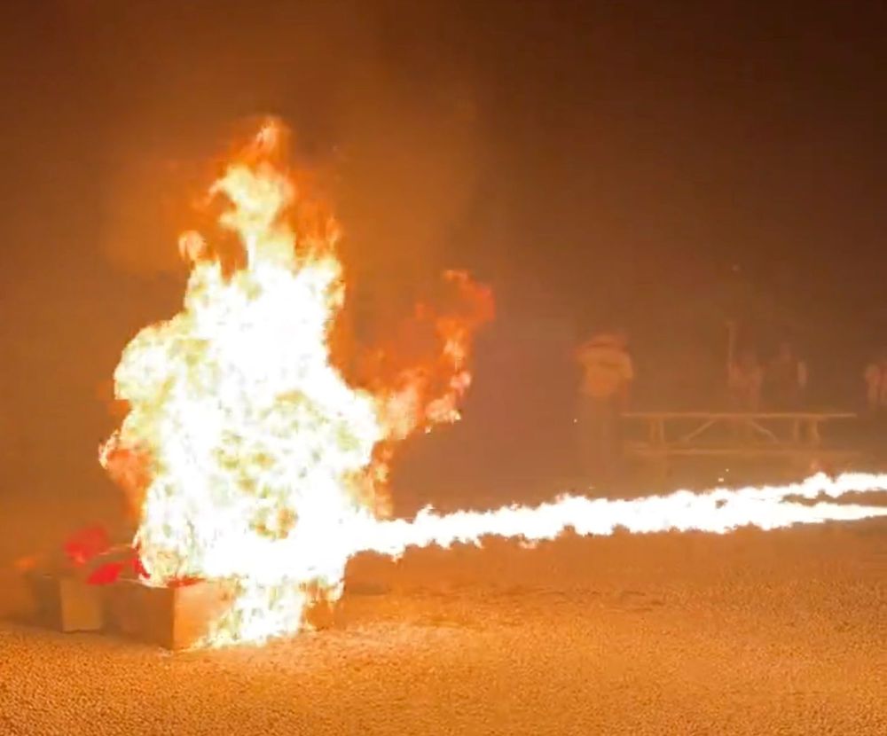 A pile of books being set on fire.