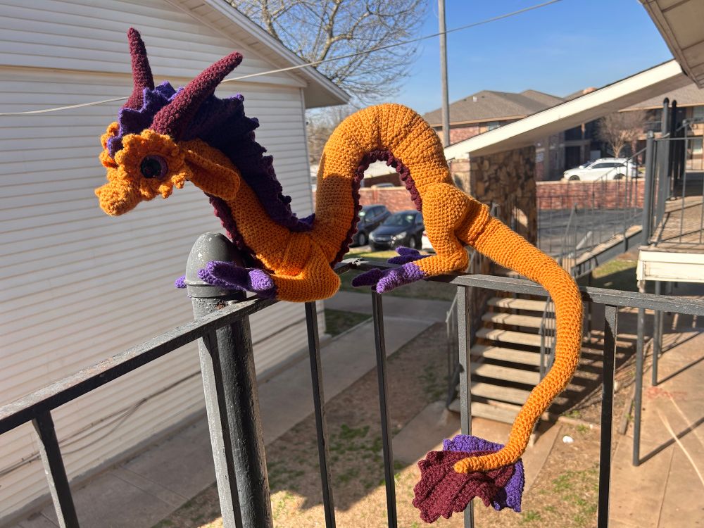 Crocheted Eastern Dragon chilling on my porch railing