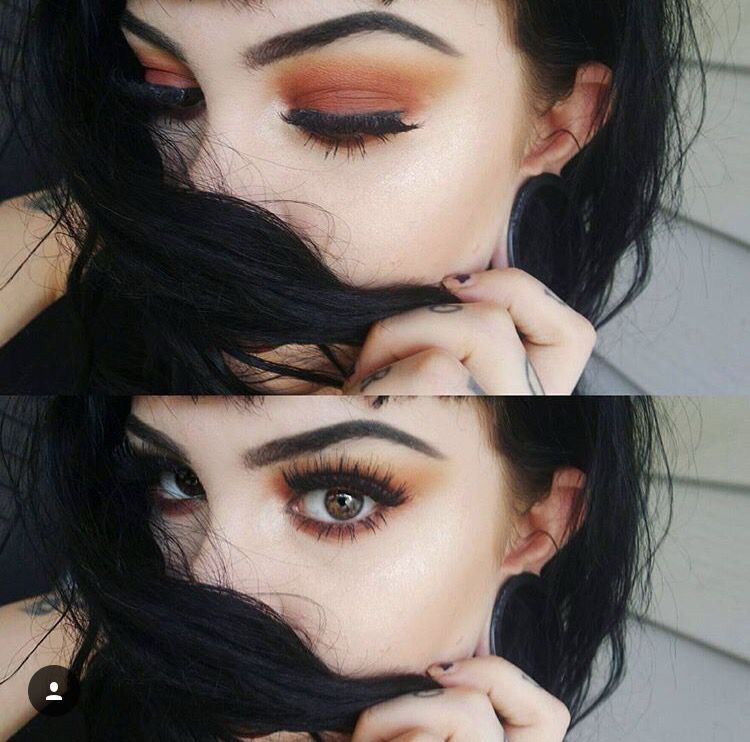 2 photos of a woman. She has dark hair and dark brows. She is wearing orange/yellow eye makeup with false lashes. In both photos she’s using her hair to cover her nose and mouth. She has large stretched ears. Her eyes are greenish brown. 
