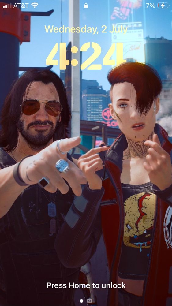 A phone lock screen that showcases Johnny Silverhand and a customized V from the game Cyberpunk 2077 (This V has pale skin, has a neck tattoo with gold cyberware on her face— her hair is half shaved on the bottom and has dyed red hair in a short half swoop at the top that covers one of her eyes… Nails are painted with a dark polish and wears a red and black SAMURAI branded jacket with a graphic tee) Johnny is pointing somewhere off camera with an unamused and disapproving frown as ‘V’ holds up two hearts (made with her index fingers and thumb crossing over one another) while looking surprised and off guard by whatever Johnny is pointing at 