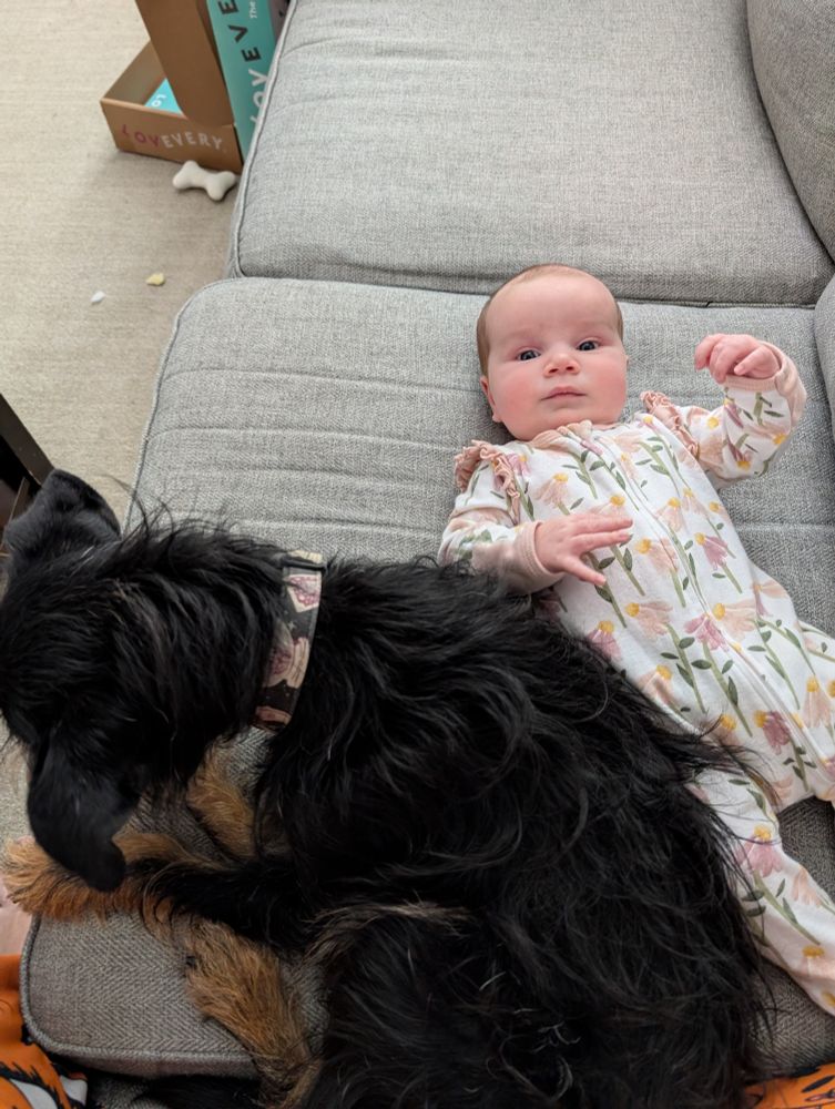 My dog and daughter sitting together on the couch 