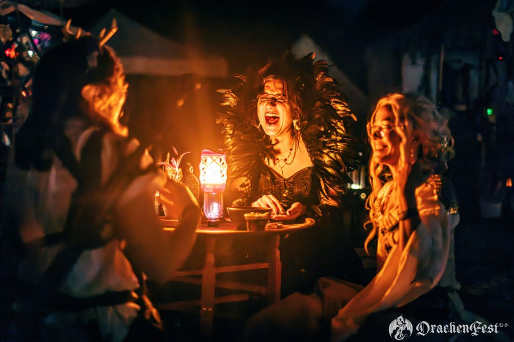 A coven of witches around a lantern 