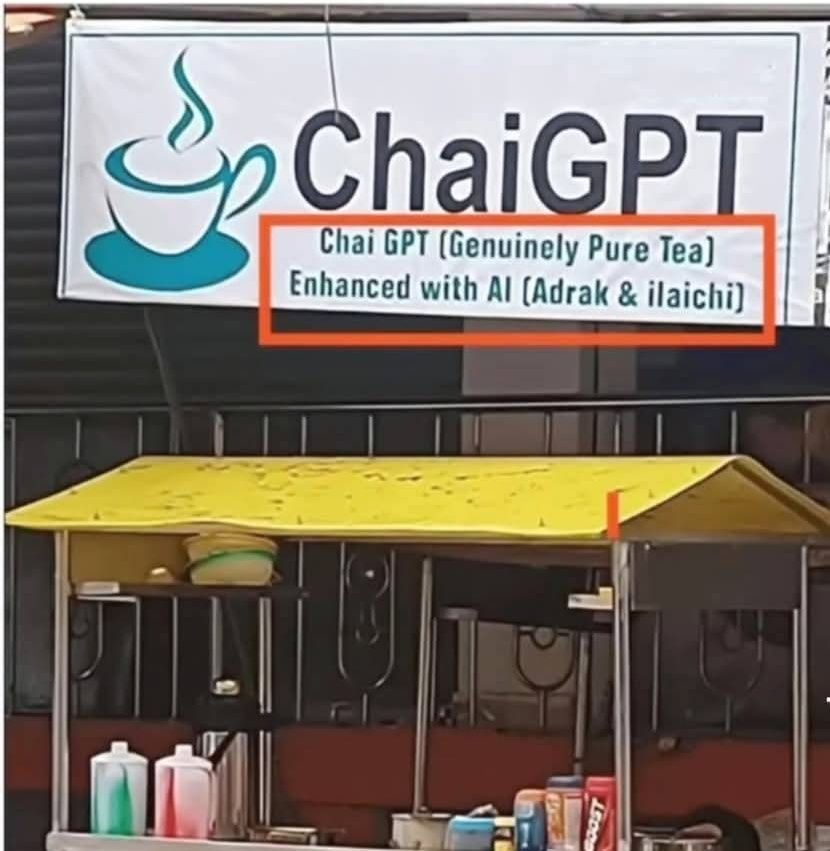 Picture is of a chai stall with the banner reading:

ChaiGPT (Genuinely Pure Tea)
Enhanced with AI (Adrak & ilaichi)