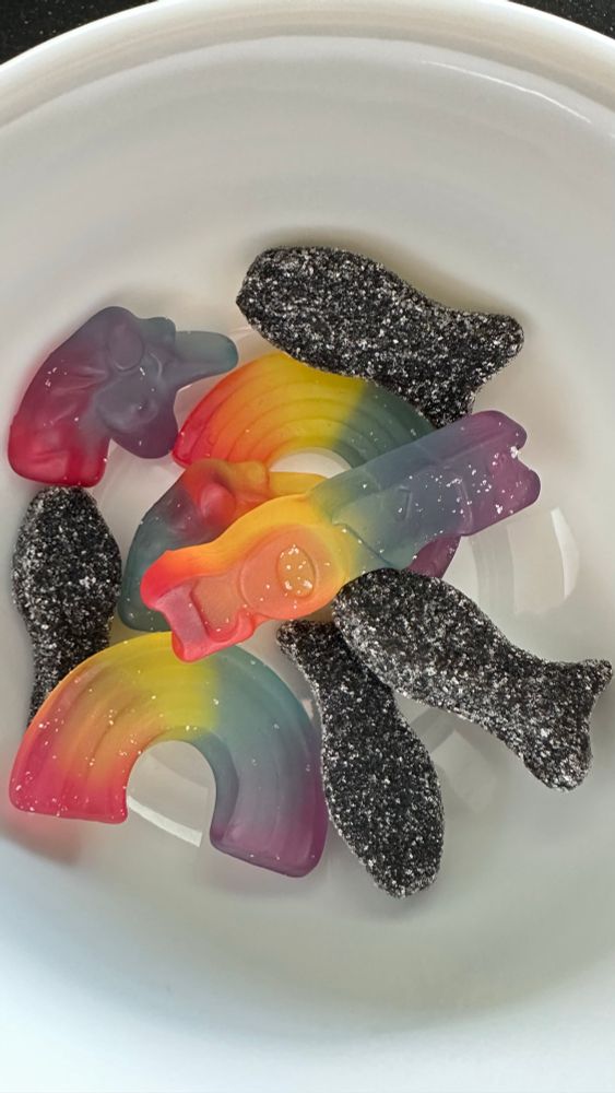 Rainbow jellies in different shaoes(unicorn, spelling love, rainbow) and salty liquorice fishies  