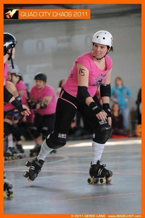 Lady Scorcher #15 warming up for a  roller derby bout in the pink CN Power (Toronto All Star Team) uniform at Quad City Chaos in 2011. photo by Derek Lang Bagelhot. 