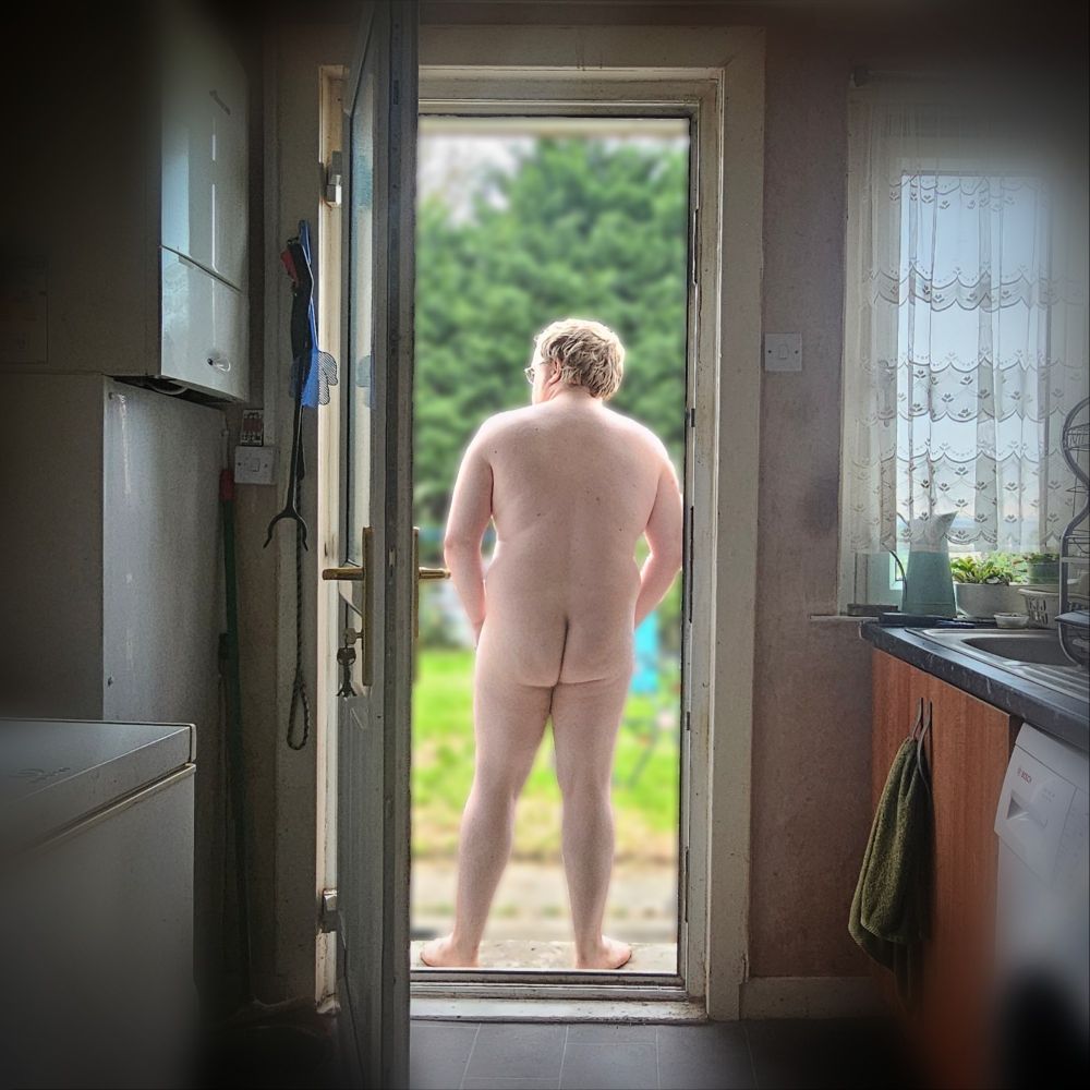 A picture of myself standing out on the doorsteps in the back garden with my back turned to the camera.