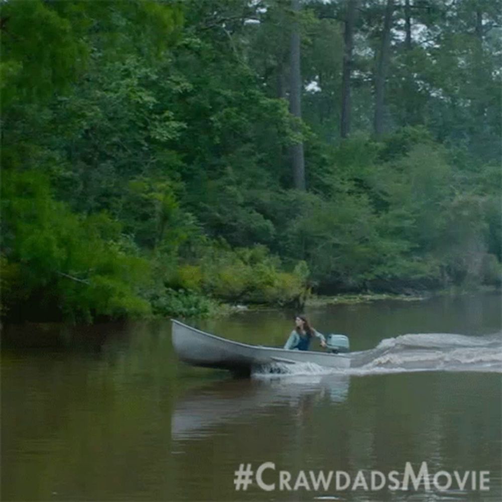 a woman is in a boat on a river with the #crawdadsmovie written on the bottom