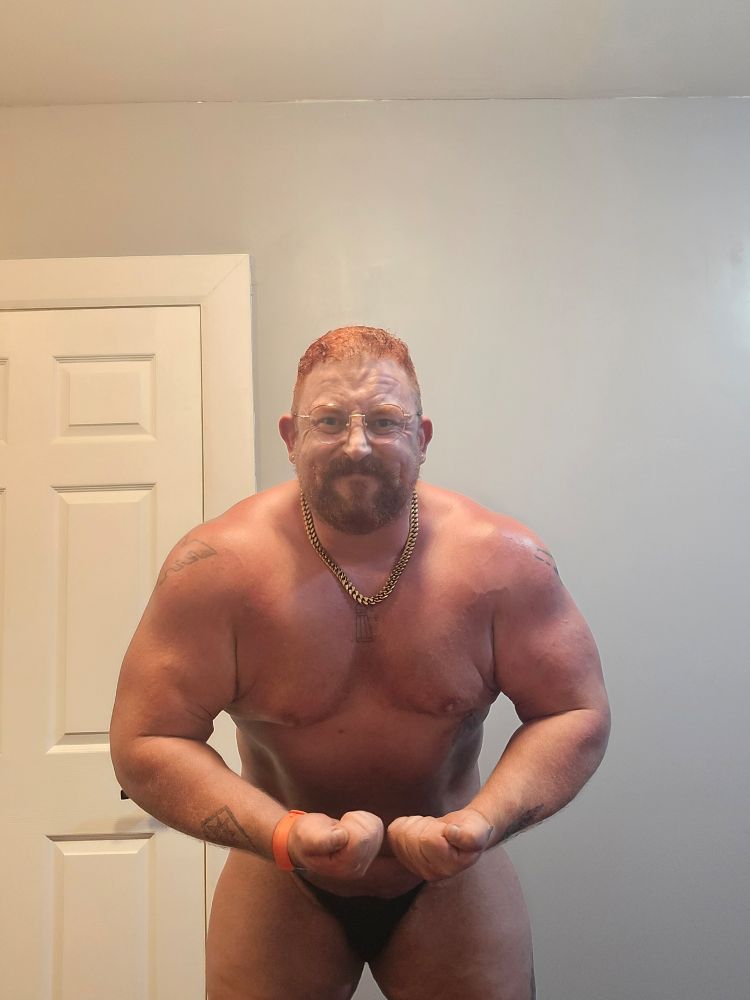 Same man performing the crab variation of a most muscular pose.