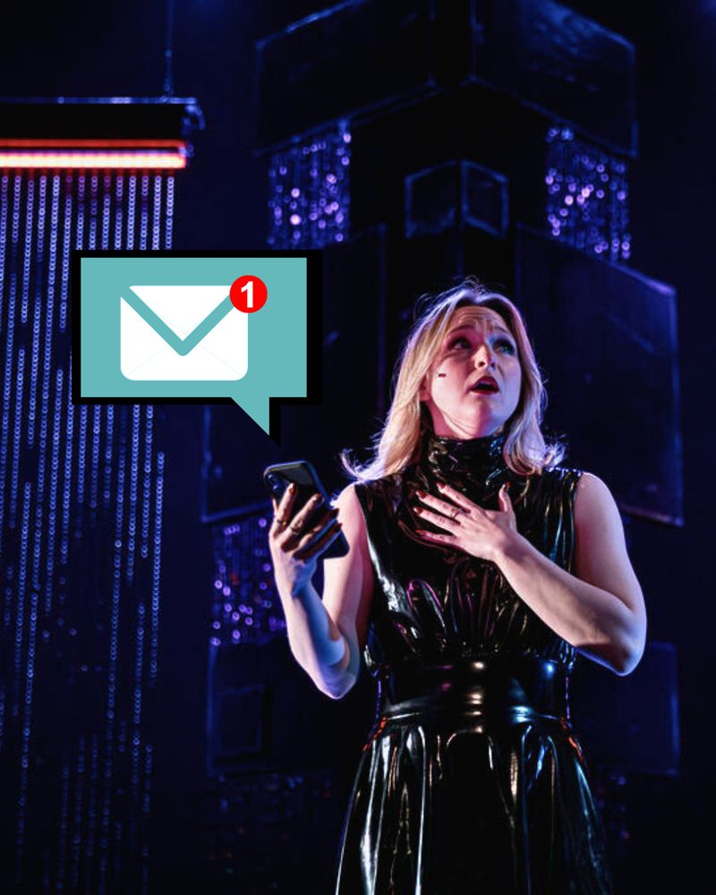 ID: An email notification emits from Lady Macbeth's phone (Annika Burley). PC: Benjamin Rose Photography.