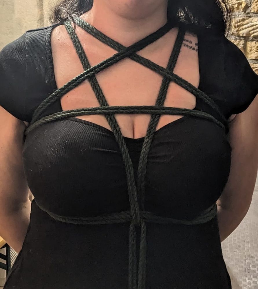 Eine weiblich gelesene Person mit Pentagram Harness aus Seil in Dunkelgrün