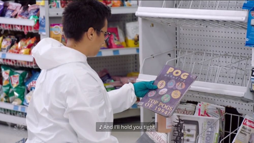 A character from the show is cleaning underneath a magazine display, beneath they find one titled "Pog Magazine". It has a few pogs on the cover with subtext that reads 'Top pogs of 1994!' lol