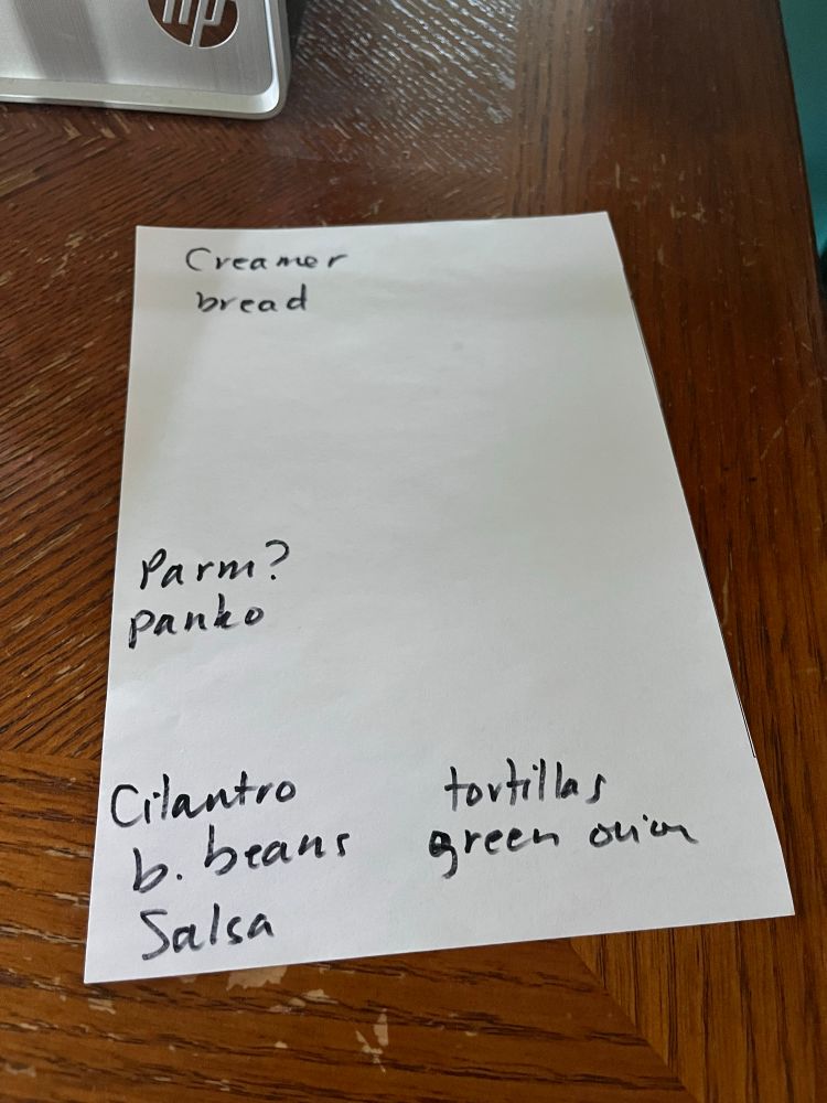 A photo of a grocery list including creamer, bread. Parm?, panko, cilantro, b. Beans, salsa, tortillas and green onion