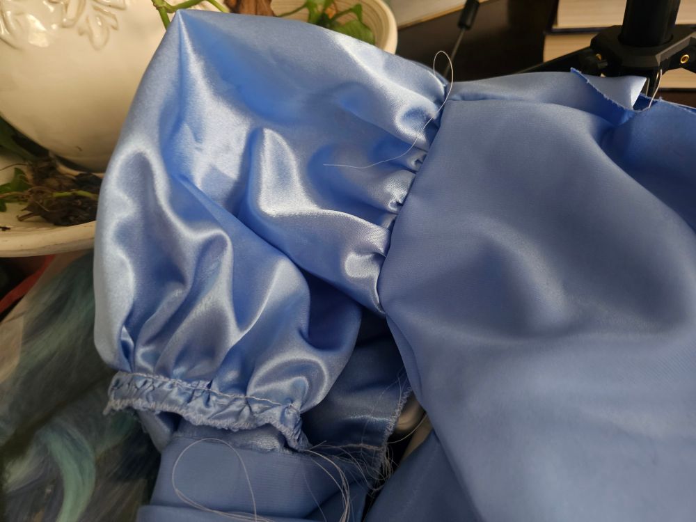 A blue bodice with one inside out sleeve