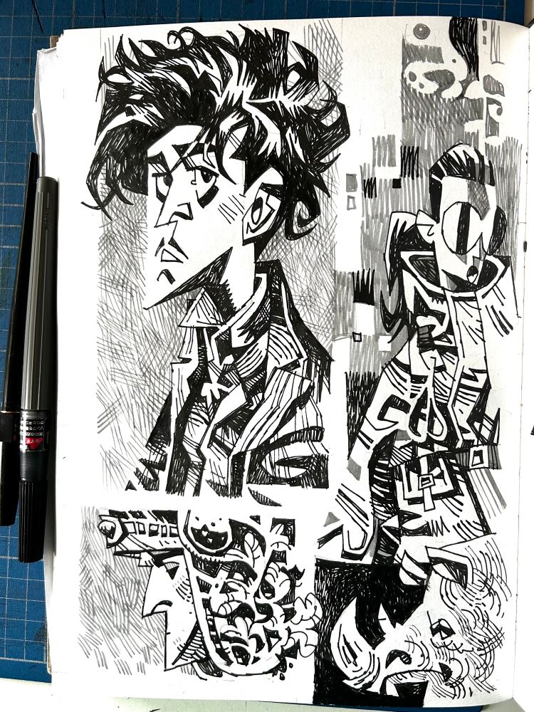 A sketchbook page of black and white drawings of people and a rhino with pens placed next to the page. 
