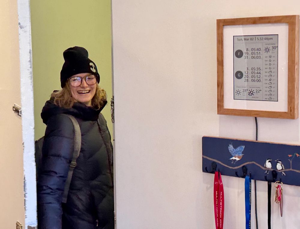 My wife Kira leaving the house after checking when her train is arriving