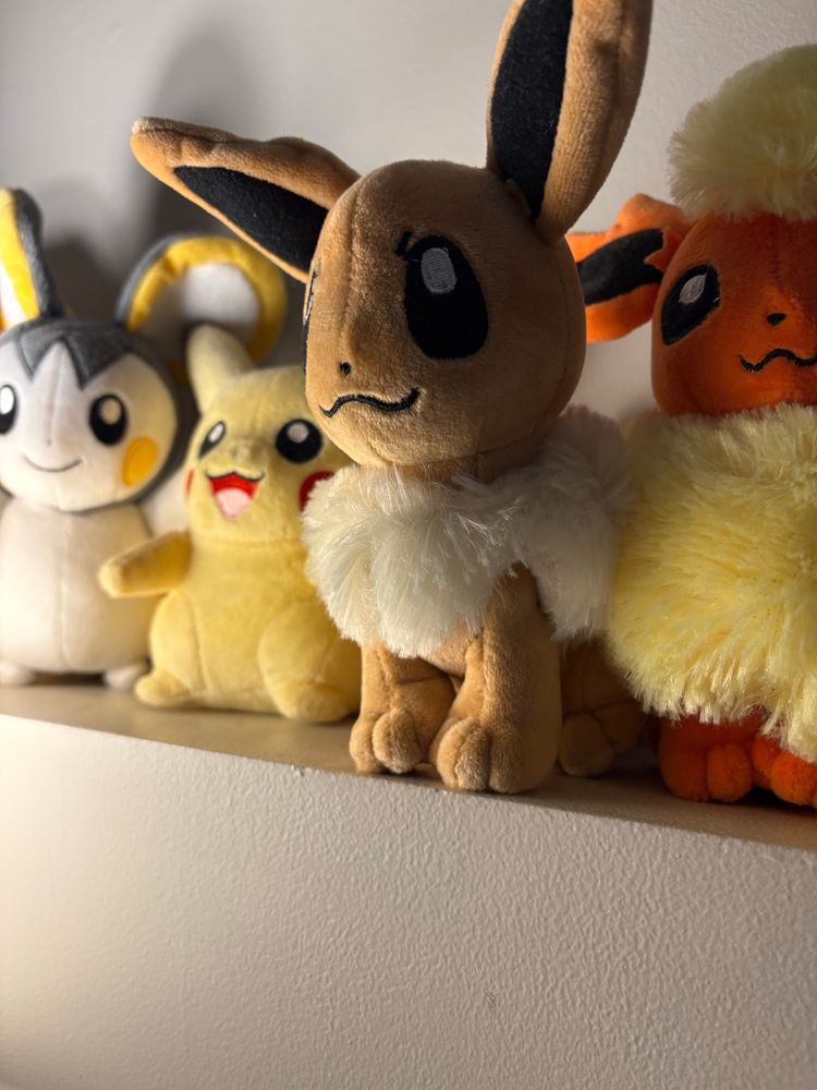 eevee plush next to a pikachu, emolga and a flareon plush 