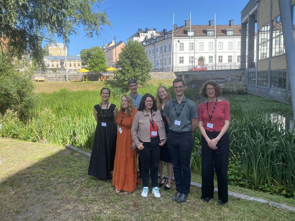 Team from the University of Vermont + External faculty posing for a picture by a river